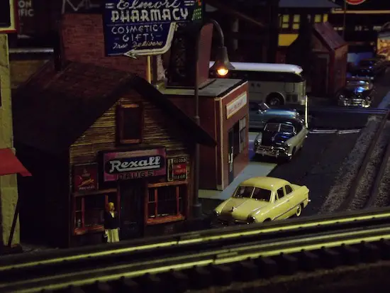 Beautiful blond young lady waiting for the 50 ford to pull up and take her on their date near the outskirts of town - on the KCS&P O Gauge Railway