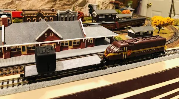 Mini Train Cam attached to a flatbed rail car with velcro to take videos of your model railroad from the engineer's perspective.